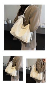 Detail of off-white tote bag featuring lace bow and embossed number ten on front