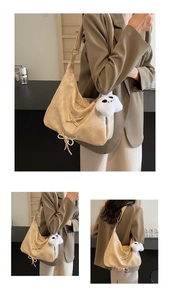 Detail of beige hobo bag with lace-up bow design and plush charm accessory