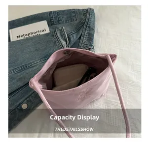 Internal capacity of pink shoulder bag showing sunglasses, wallet and magnetic closure