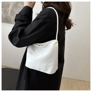 Detail of white nylon underarm bag featuring Pretty and liberty embroidery with zipper