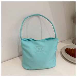 Detail of light blue bucket bag with pretty and libety embroidery and single handle