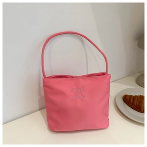 Detailed view of pink nylon bucket bag with pretty and liberty embroidery