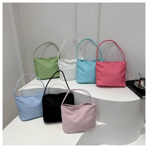 Fashionable embroidered nylon handbags in 7 colors displayed on minimalist pedestals