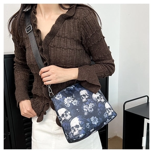 Detail of nylon tote bag with navy skull and white floral print with wide strap