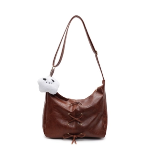 Brown vintage hobo shoulder bag with lacing, bow detail and plush star charm
