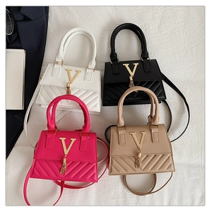 Detailed view of four colors of quilted flap bags with golden V logo and stylish tassels