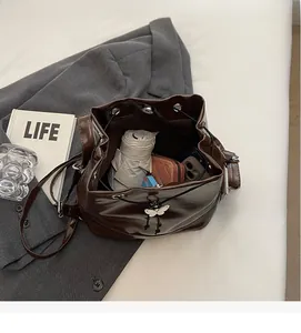 Top view of a brown leather bucket bag showing spacious interior with daily essentials