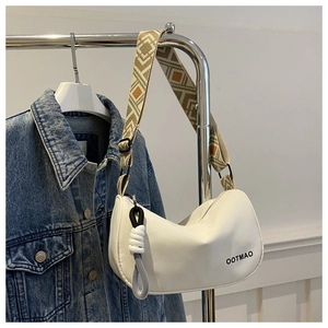 Detail of white moon bag with OOTMAO logo and geometric woven wide shoulder strap