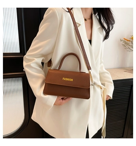 Brown lychee leather bag styled with a white blazer for a modern professional look