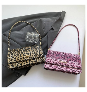 Detail of leopard print baguette bags with gold metal bars and slim shoulder straps