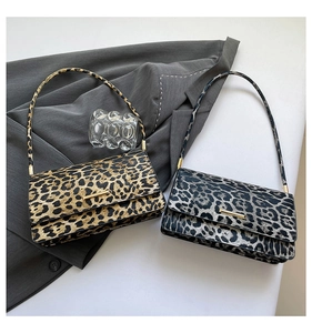 Detail showing leopard print shoulder bags in classic yellow and chic grey with gold buckles