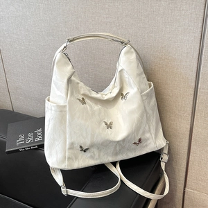 Chic cream pleated tote bag with silver metal butterfly accents and adjustable straps