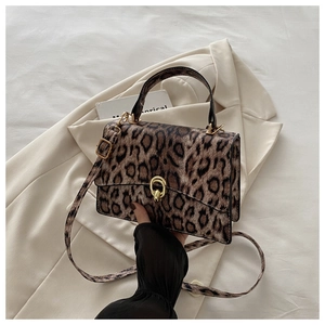 Close-up of leopard print PU leather bag showing animal texture and metal twist lock