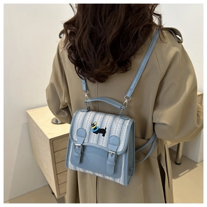 Chic light blue striped canvas backpack with faux leather details and dog embroidery