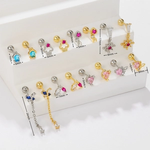 Detailed macro view of assorted gold and silver piercing studs with colorful zircons