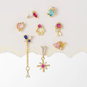 Set of 8 dainty gold-plated earrings featuring pink hearts, zircon butterflies, and star motifs