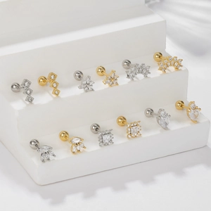 Set of surgical steel stud earrings with heart and snowflake designs in gold and silver