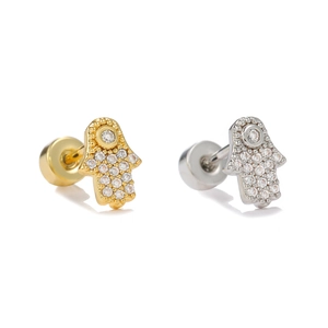 Detailed close-up of gold and silver Hamsa Hand labret studs with pavé cubic zirconia