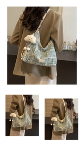 Detail of green and white geometric canvas tote with cloud plush charm and cream strap
