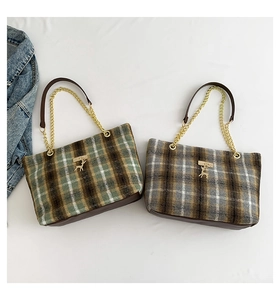 Top view of two plaid tote bags with gold chains and reindeer charms in vintage style