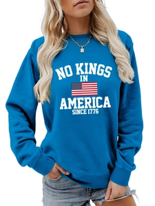 Detail of blue crewneck sweatshirt with No Kings in America print and ribbed cuffs