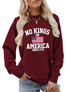 Detail of maroon crewneck sweatshirt with white American flag and patriotic slogan print