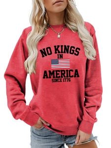 Detail of red crewneck sweatshirt with No Kings in America print and ribbed cuffs