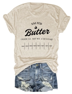 Close-up of salted butter typography print on beige crew neck short sleeve t-shirt