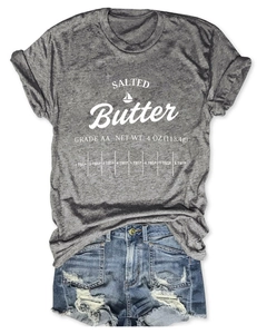 Detailed view of grey T-shirt with white Salted Butter graphic print and denim shorts