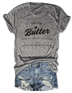 Close-up of salted butter print on grey t-shirt paired with denim shorts flat lay