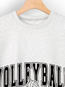 Detailed view of the round neckline and vintage volleyball print on a gray sweatshirt