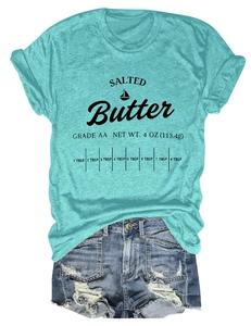 Detail of mint green t-shirt with salted butter print and distressed denim shorts