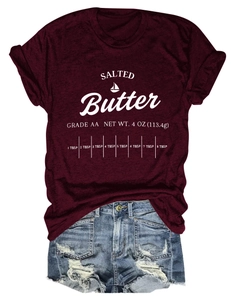 Detail of burgundy T-shirt with salted butter print and ripped denim shorts on white background