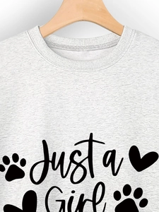 Detail of ribbed crewneck on gray sweatshirt with Just a Girl and paw print graphic