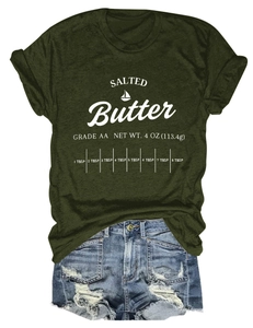 Flat lay of army green t-shirt with salted butter print and distressed denim shorts