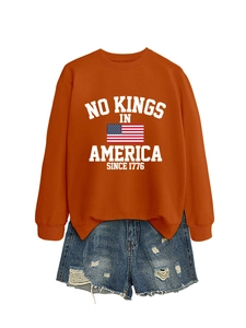 Retro style orange sweatshirt with No Kings in America print and distressed denim shorts