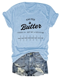 Flat lay of women's blue T-shirt with Salted Butter print and ripped denim shorts