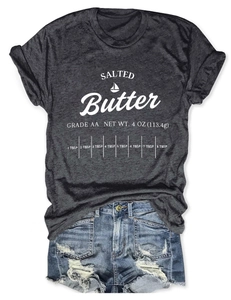 Detailed view of dark grey salted butter graphic t-shirt paired with denim shorts