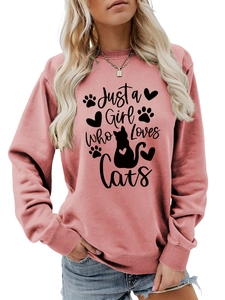 Detail of Just a Girl Who Loves Cats text and feline silhouettes on pink sweatshirt