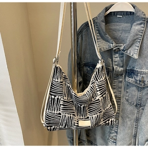 Detailed view of large black and white striped canvas tote bag with woven texture