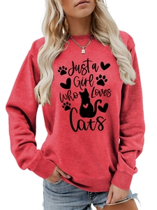 Close-up of red crewneck sweatshirt featuring Just a Girl Who Loves Cats graphic print