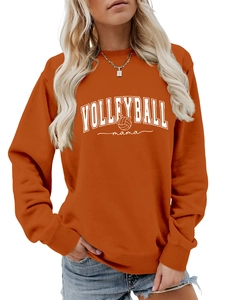 Close-up of the ribbed neckline and Volleyball Mama graphic print on the orange sweatshirt