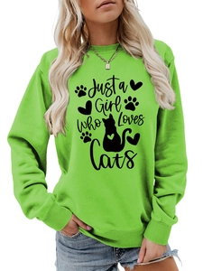 Detail of lime green sweatshirt featuring Just a Girl Who Loves Cats graphic print