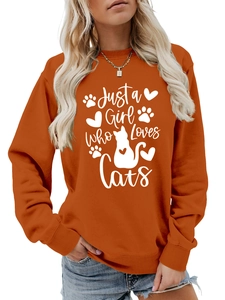 Detail of orange crewneck sweatshirt with 'Just a Girl Who Loves Cats' print and ribbed cuffs