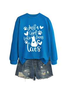 Flat lay of blue sweatshirt with Just a Girl Who Loves Cats print and ripped denim shorts