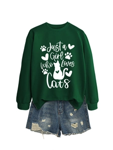 Detail of dark green sweatshirt with white cat lover print and frayed denim shorts