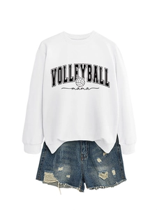 Detailed view of white volleyball mama sweatshirt paired with distressed denim shorts