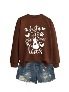 Flat lay of brown long sleeve cat print sweatshirt and blue distressed denim shorts set