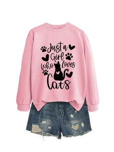 Detail of pink sweatshirt with 'Just a Girl Who Loves Cats' print and frayed denim shorts
