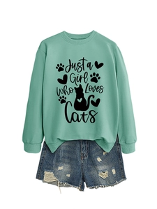Detail of mint green sweatshirt with Just a Girl Who Loves Cats print and denim shorts